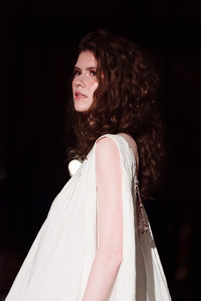 runway photographer closeup of model Elizabeth RA Victoria walking for Aspect Doré at the Oxford Fashion Show at Paris Fashion Week 2019