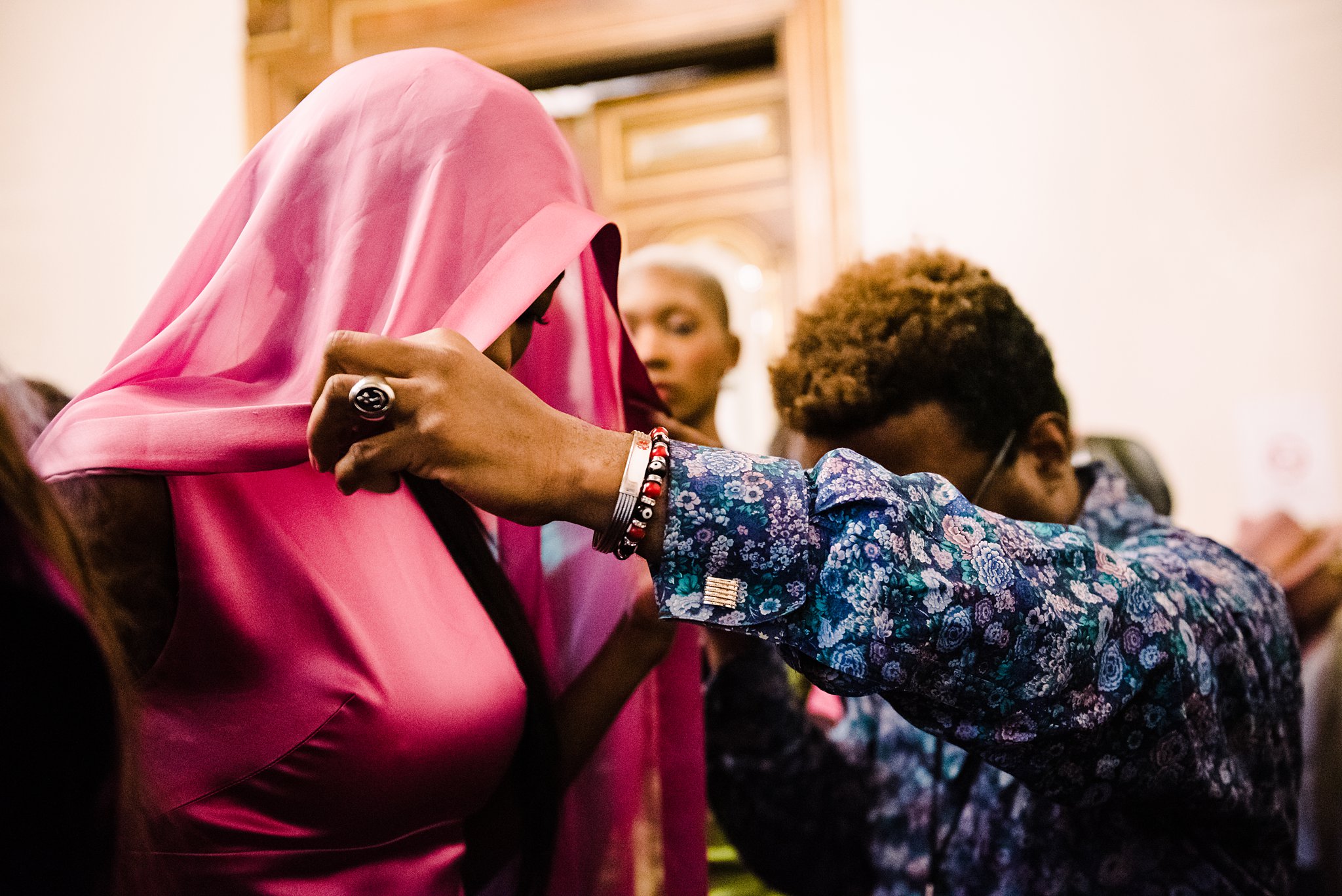 styling a pink hood on a model at paris fashion week, backstage at the flying solo show ss20