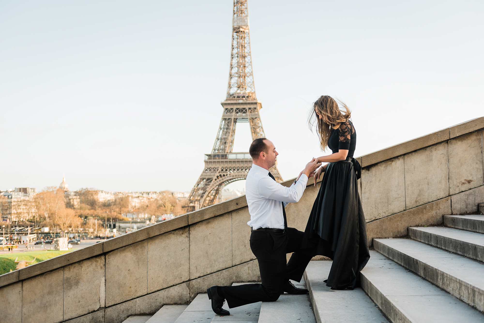 Jennifer and Yannick's Surprise Paris Proposal Photo Shoot at the Eiffel Tower - sliding the ring onto her finger
